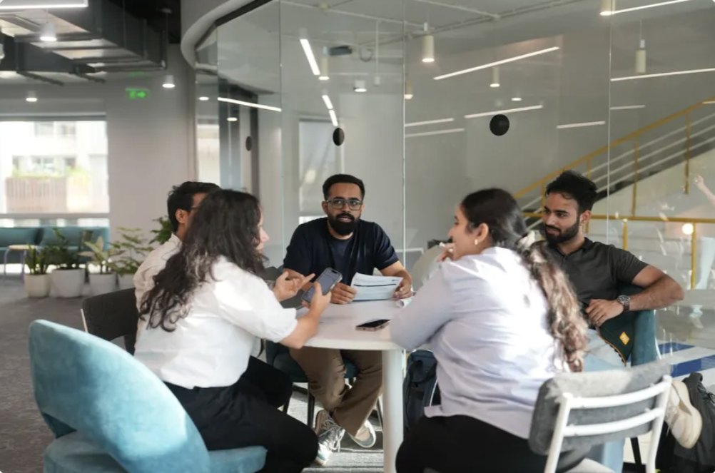 A team discussing their build with a mentor