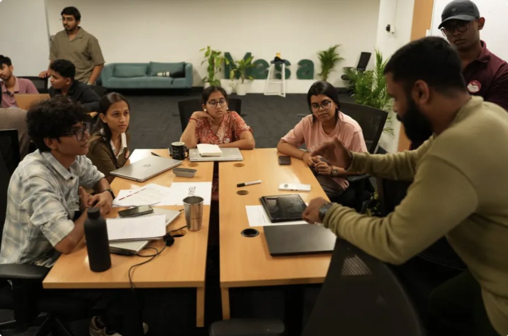 Students working through a build session around a table