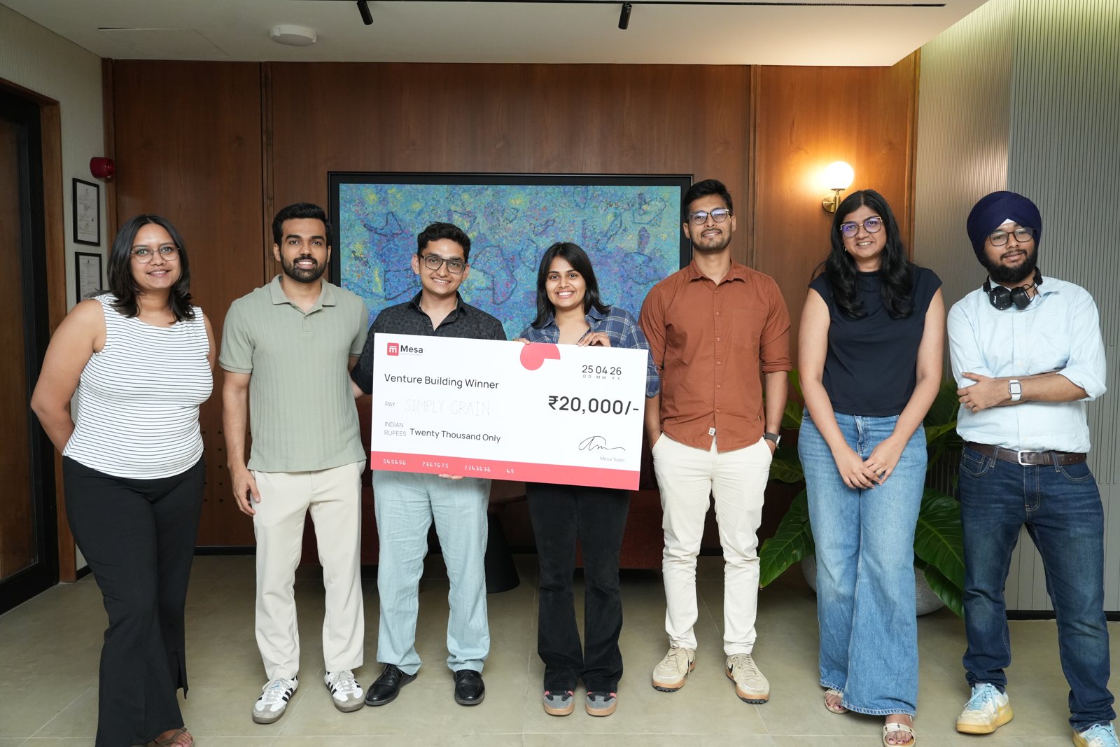 The winning team holding a Mesa winner cheque with mentors