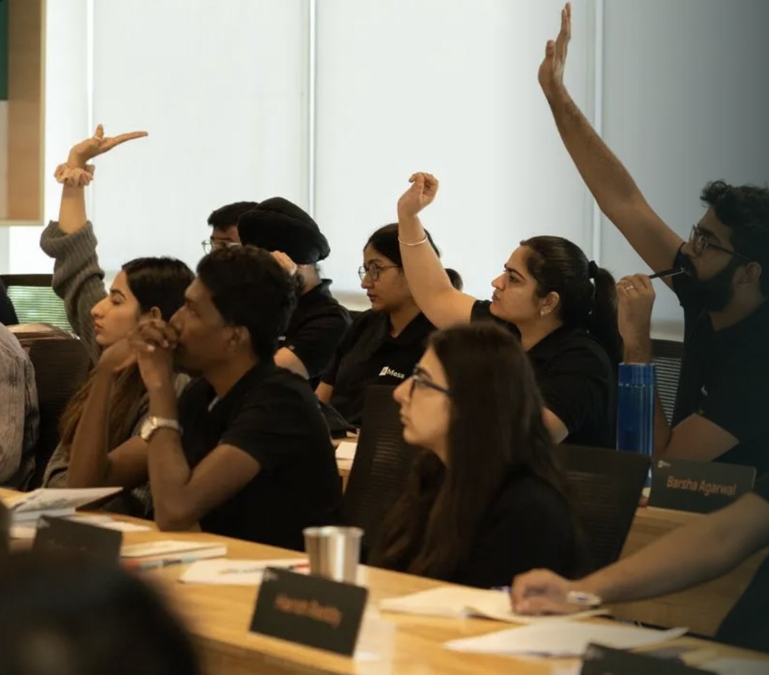 Students raising their hands in a Mesa class
