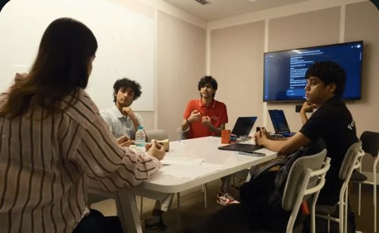 Students in a sales role-play around a table