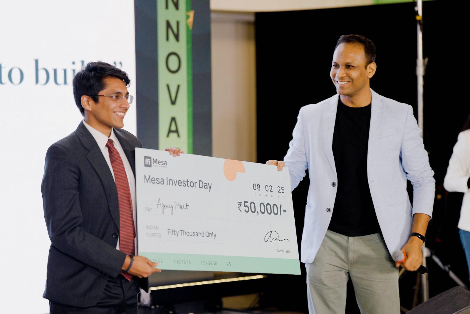 A founder receiving a ₹50,000 cheque on stage at Mesa Investor Day