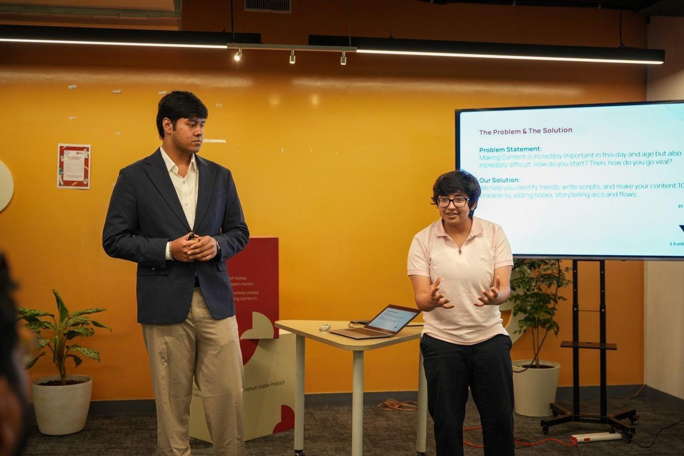 Two founders pitching their startup to a room