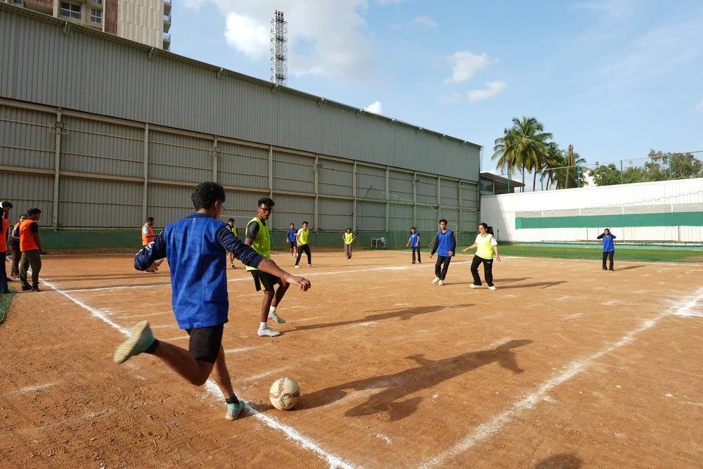 A football match on a dirt ground