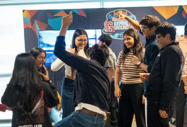 Students crowding a games booth at Maverion
