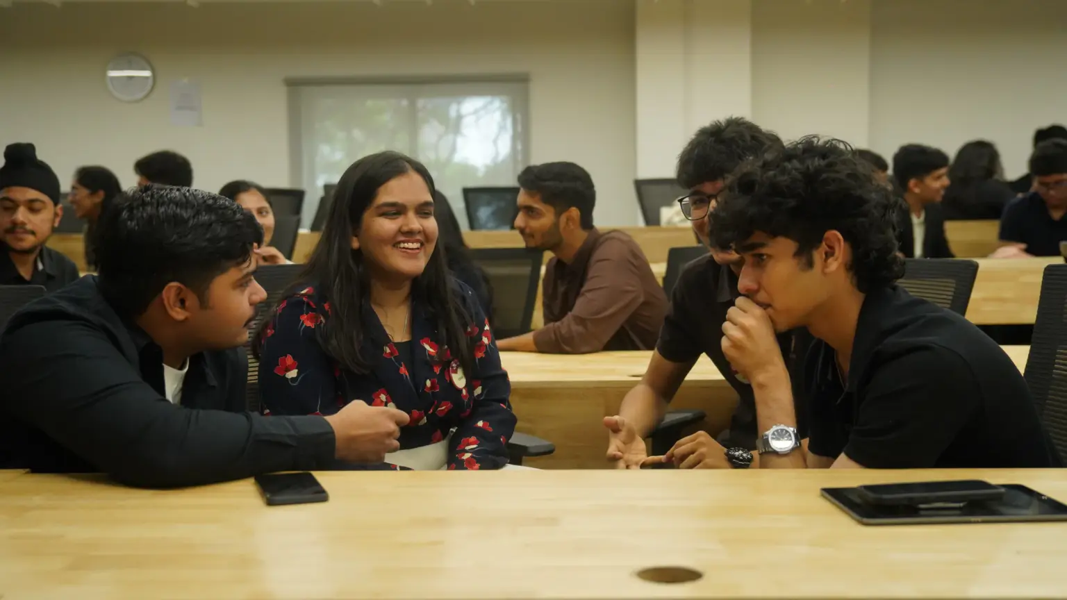 Mesa School undergraduate students talking together during a class